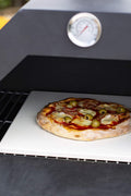 "Stainless steel outdoor pizza oven with chimney and stone insert"

"Dual-fuel pizza oven setup with wood and gas burners"

"Outdoor stainless pizza oven in backyard setting"

"Compact portable pizza oven on patio table"

"Fully cooked pizza inside stainless oven"