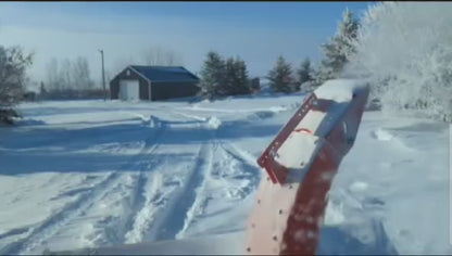Extreme-duty red snow blower attachment for skid steer – front view

Hydraulic chute adjustment system on 84" snow blower model

72" skid steer snow blower attachment mounted for municipal use

Skid steer operator using snow blower in snowy mountain terrain

Rear hydraulic connection and chute control close-up on snow blower