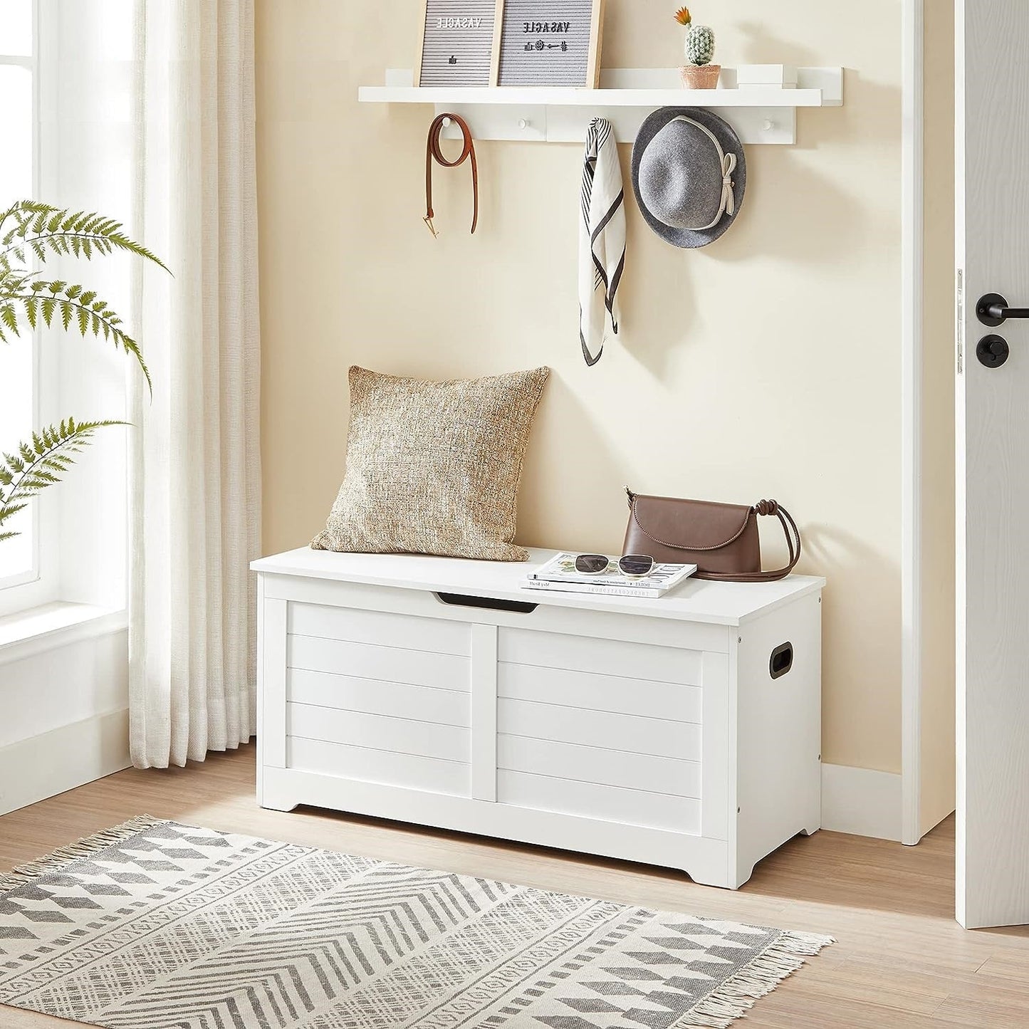 white storage bench with cushion in hallway
shoe bench with hidden storage compartment
cushioned seat chest for entryway organization
white wooden entryway bench with lift-top lid
modern shoe storage bench for bedrooms