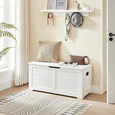 white storage bench with cushion in hallway
shoe bench with hidden storage compartment
cushioned seat chest for entryway organization
white wooden entryway bench with lift-top lid
modern shoe storage bench for bedrooms