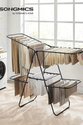 Foldable 2-Level Laundry Drying Rack - Full View
SONGMICS Drying Rack with Adjustable Wings - Side Angle
Foldable Drying Rack with Sock Clips - Close-Up
SONGMICS Indoor Drying Rack in Laundry Room
Foldable Laundry Drying Stand - Compact Storage Mode