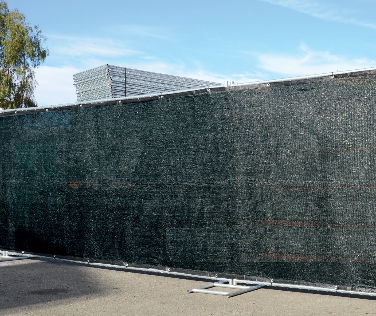 UV-resistant HDPE privacy fence cover attached to outdoor fencing