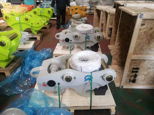 Excavator pin grabber coupler kits organized in warehouse
Yellow hydraulic pin grabber attached to excavator arm