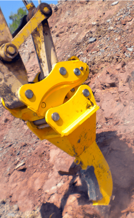 Excavator pin grabber coupler kits organized in warehouse
Yellow hydraulic pin grabber attached to excavator arm